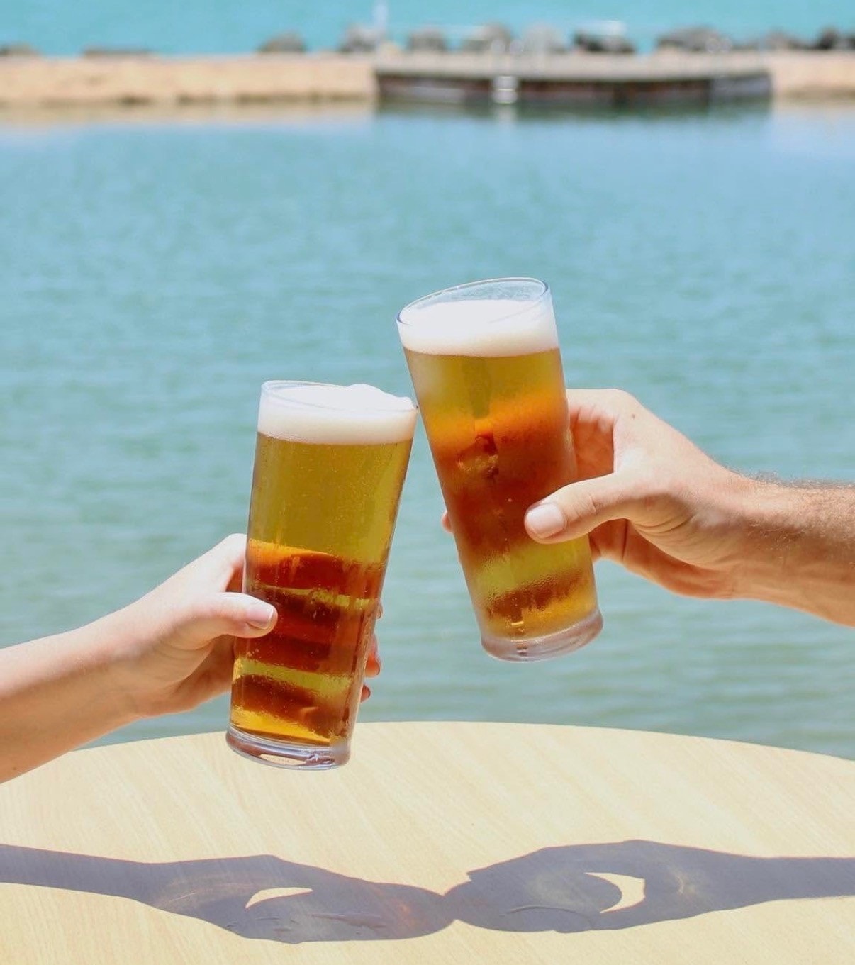 Toasting cold beers at the waterfront